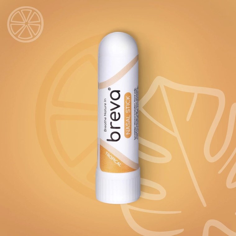 Tropical Nasal Stick, turuncu bir zeminde portakal dilimi çizimiyle birlikte duruyor.